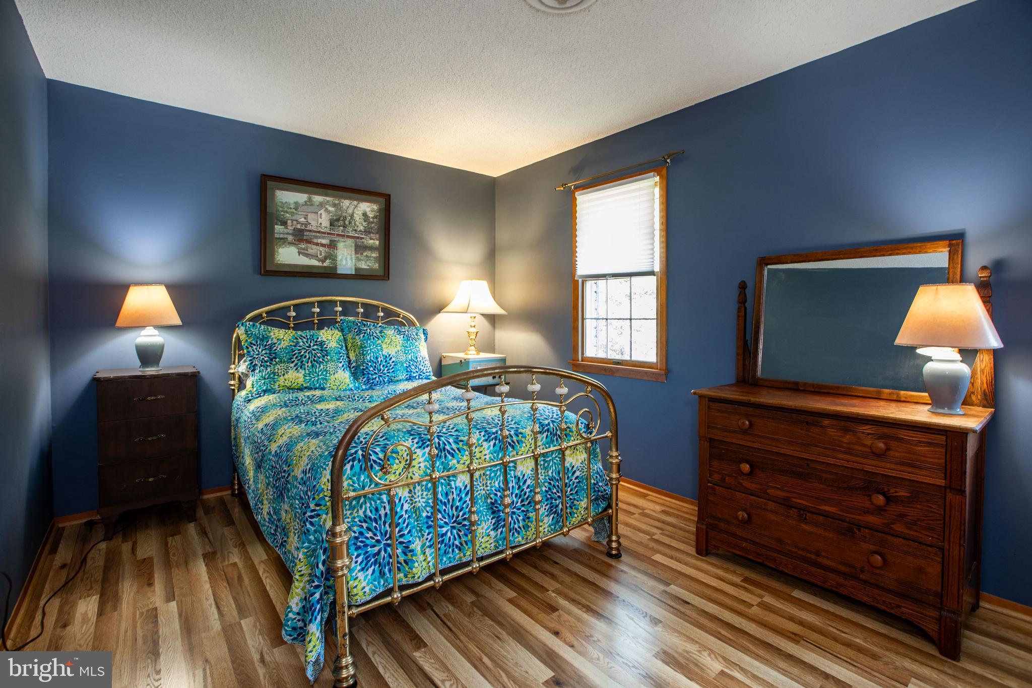 12 Millstream Road Cream Ridge, NJ 08514 - Photo 54 of 76 a bedroom with a bed and wooden floor