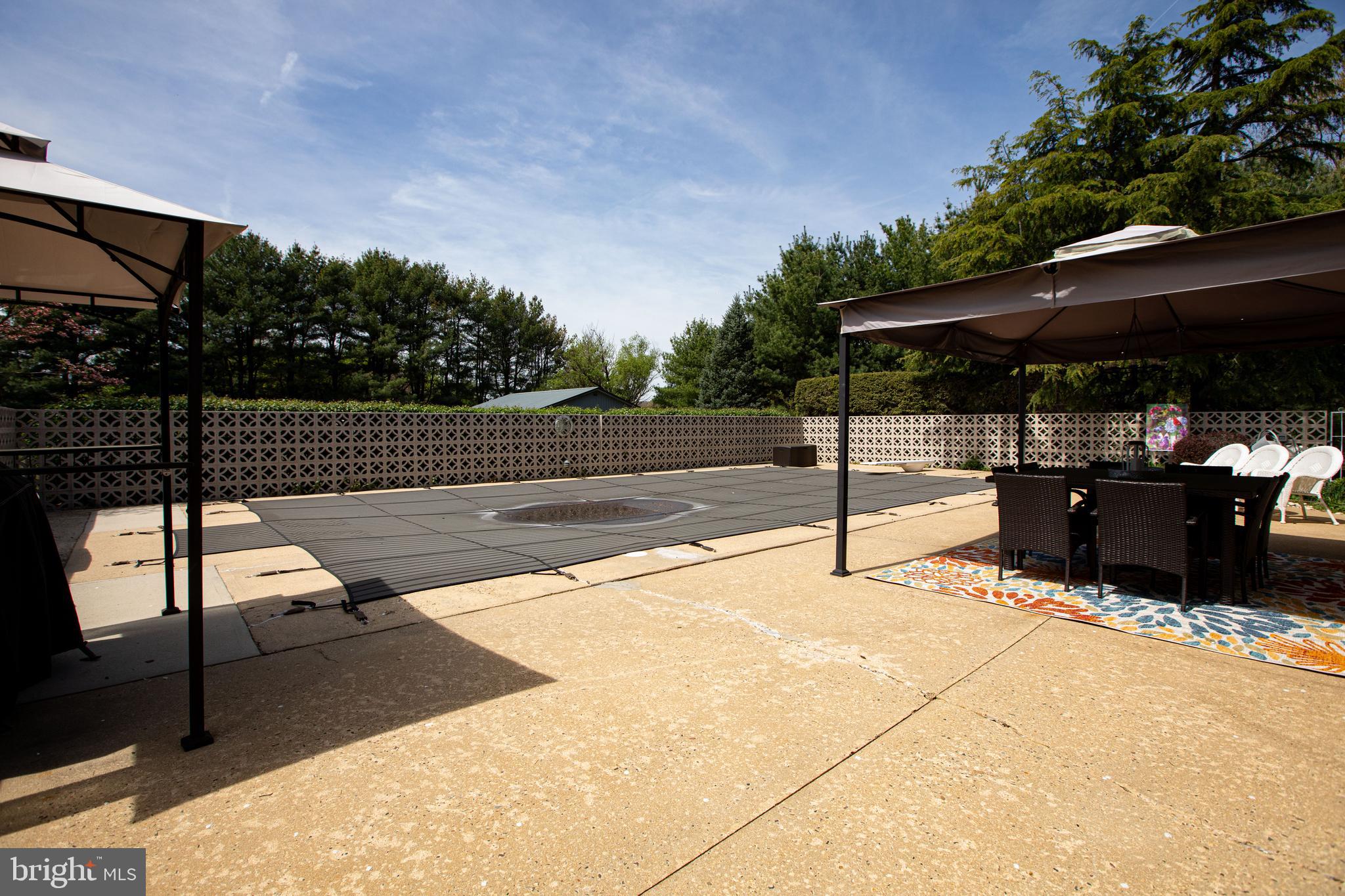 12 Millstream Road Cream Ridge, NJ 08514 - Photo 66 of 76 a view of a patio with table and chairs a barbeque with wooden fence