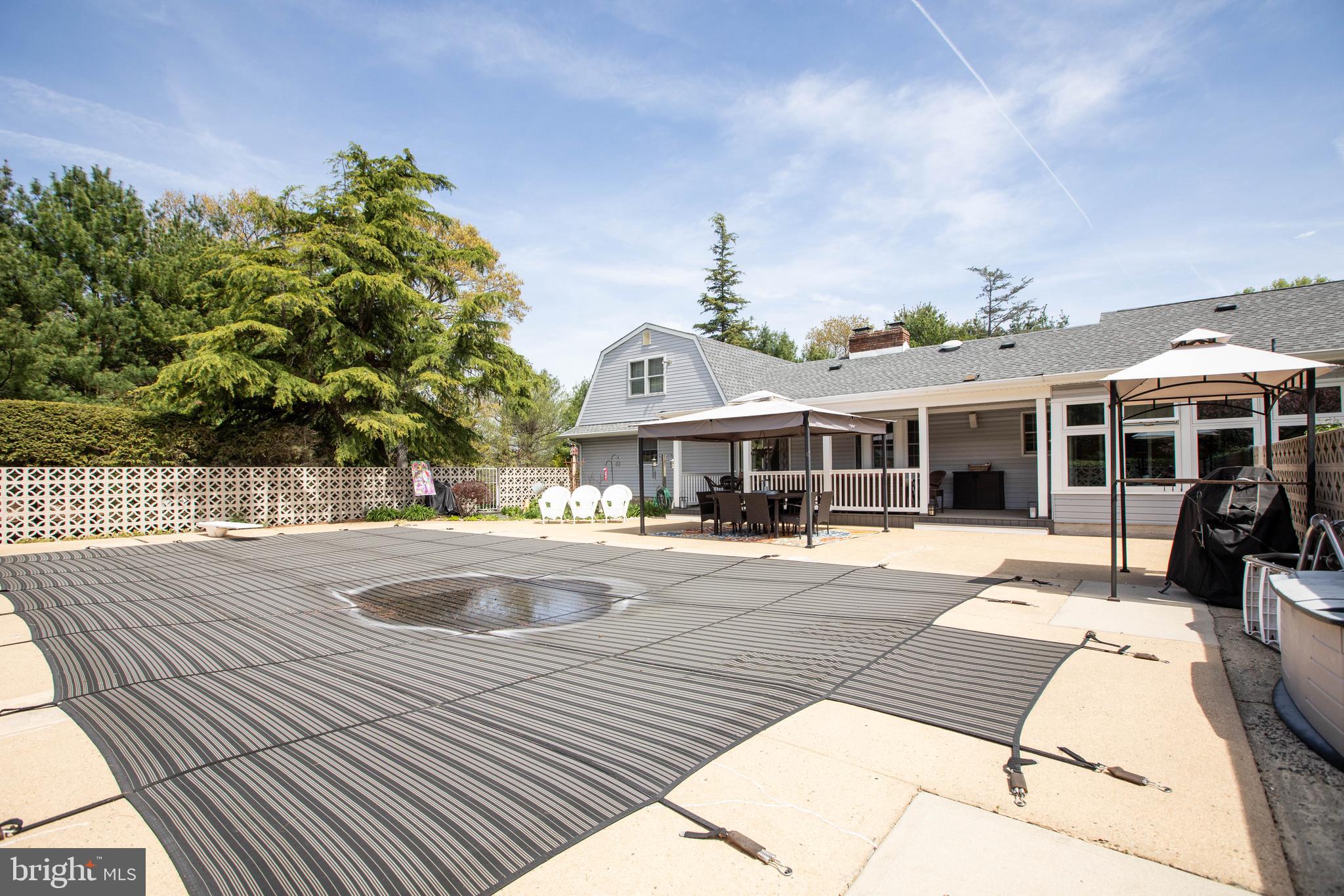 12 Millstream Road Cream Ridge, NJ 08514 - Photo 67 of 76 a front view of house with yard outdoor seating and barbeque in the background