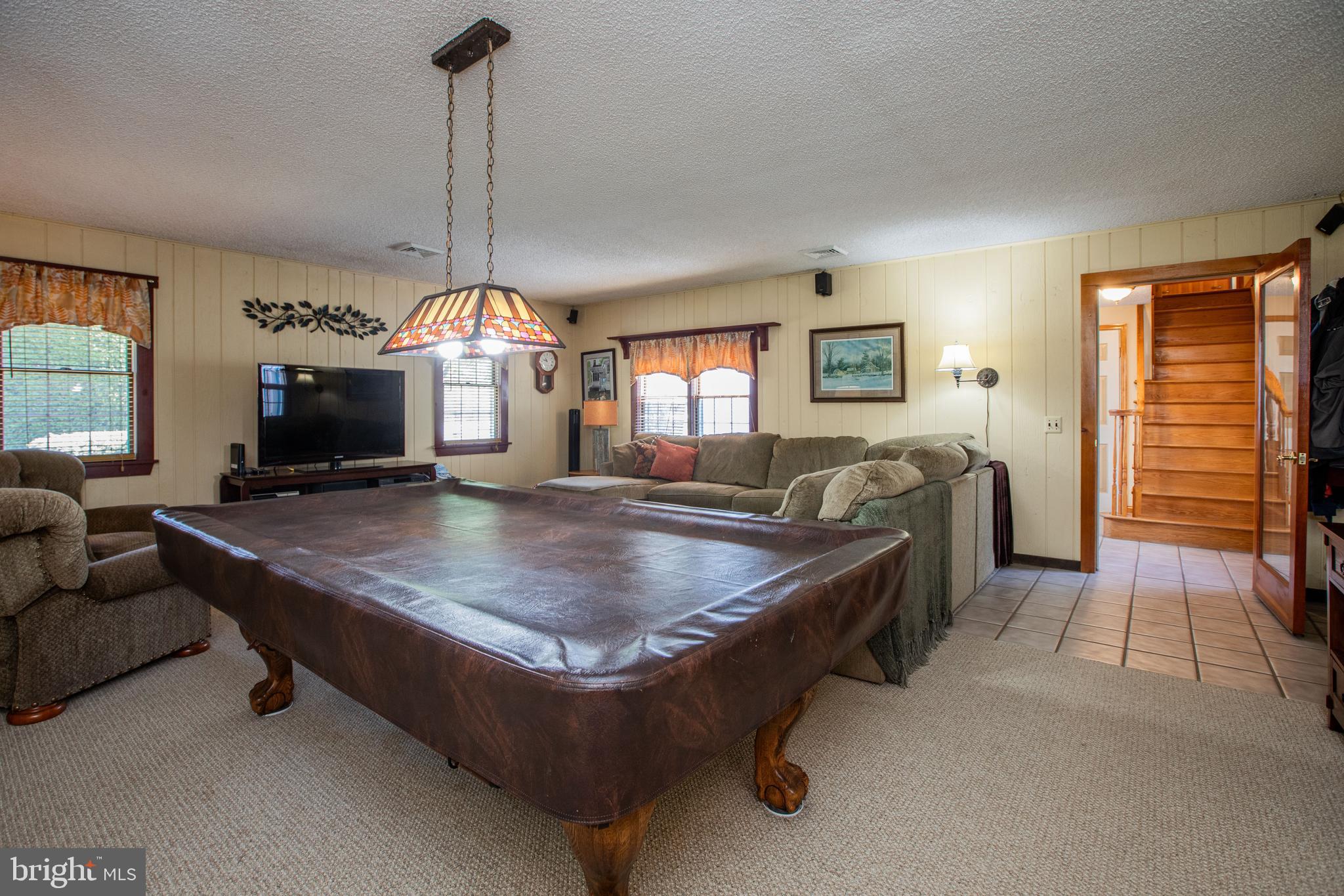 12 Millstream Road Cream Ridge, NJ 08514 - Photo 9 of 76 a living room with furniture a fireplace and a chandelier