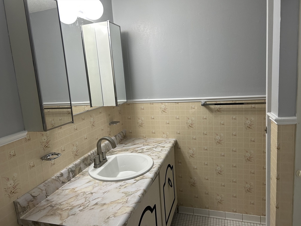 71 Nassau Drive, Unit 71 Springfield, MA 01129 - Photo 11 of 19 a bathroom with a sink and a mirror