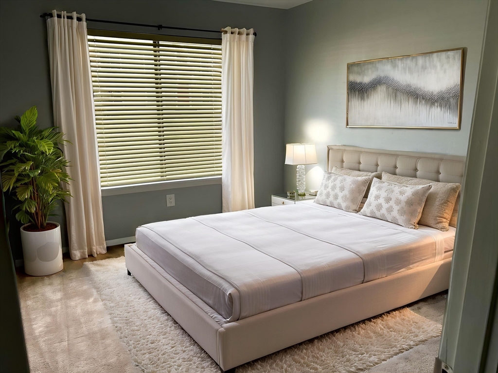 71 Nassau Drive, Unit 71 Springfield, MA 01129 - Photo 12 of 19 a bedroom with a large bed and a potted plant