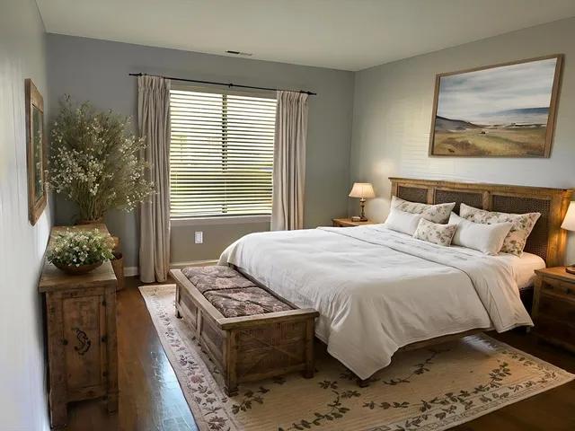 a bedroom with a bed and a painting on the wall