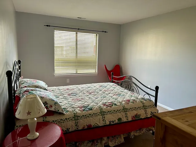 a bedroom with a bed and dresser