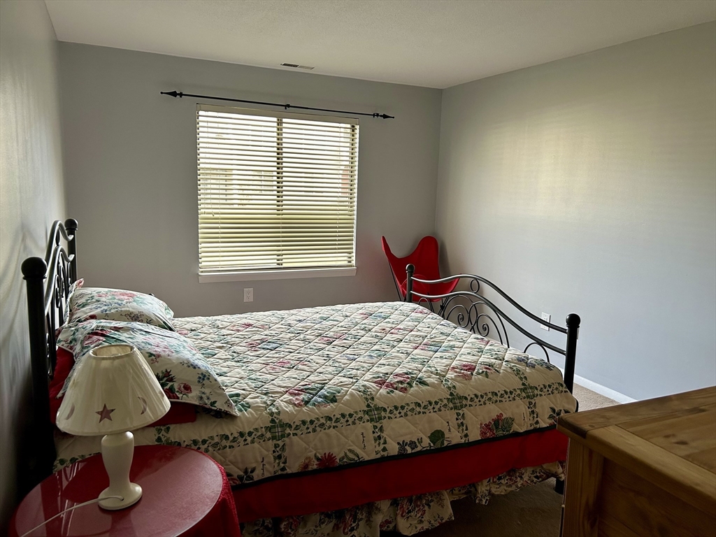 71 Nassau Drive, Unit 71 Springfield, MA 01129 - Photo 6 of 19 a bedroom with a bed and dresser