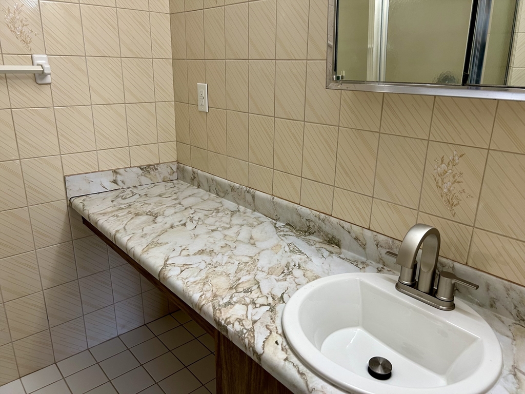 71 Nassau Drive, Unit 71 Springfield, MA 01129 - Photo 8 of 19 a bathroom with a sink and vanity