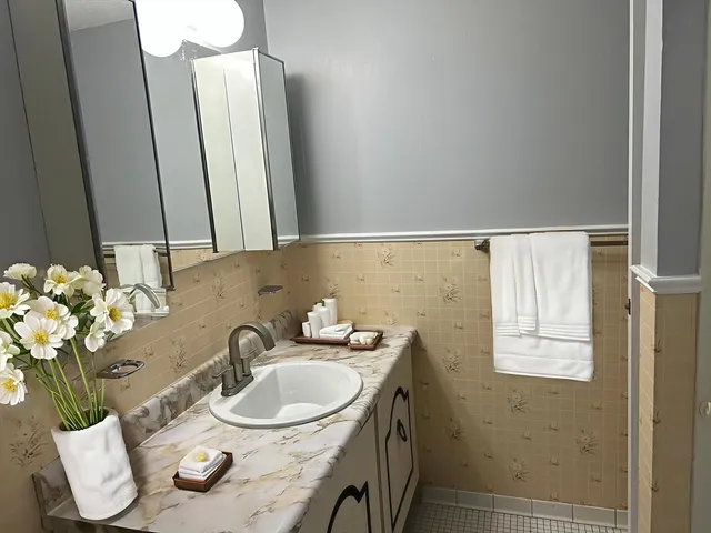 a bathroom with a sink toilet and mirror
