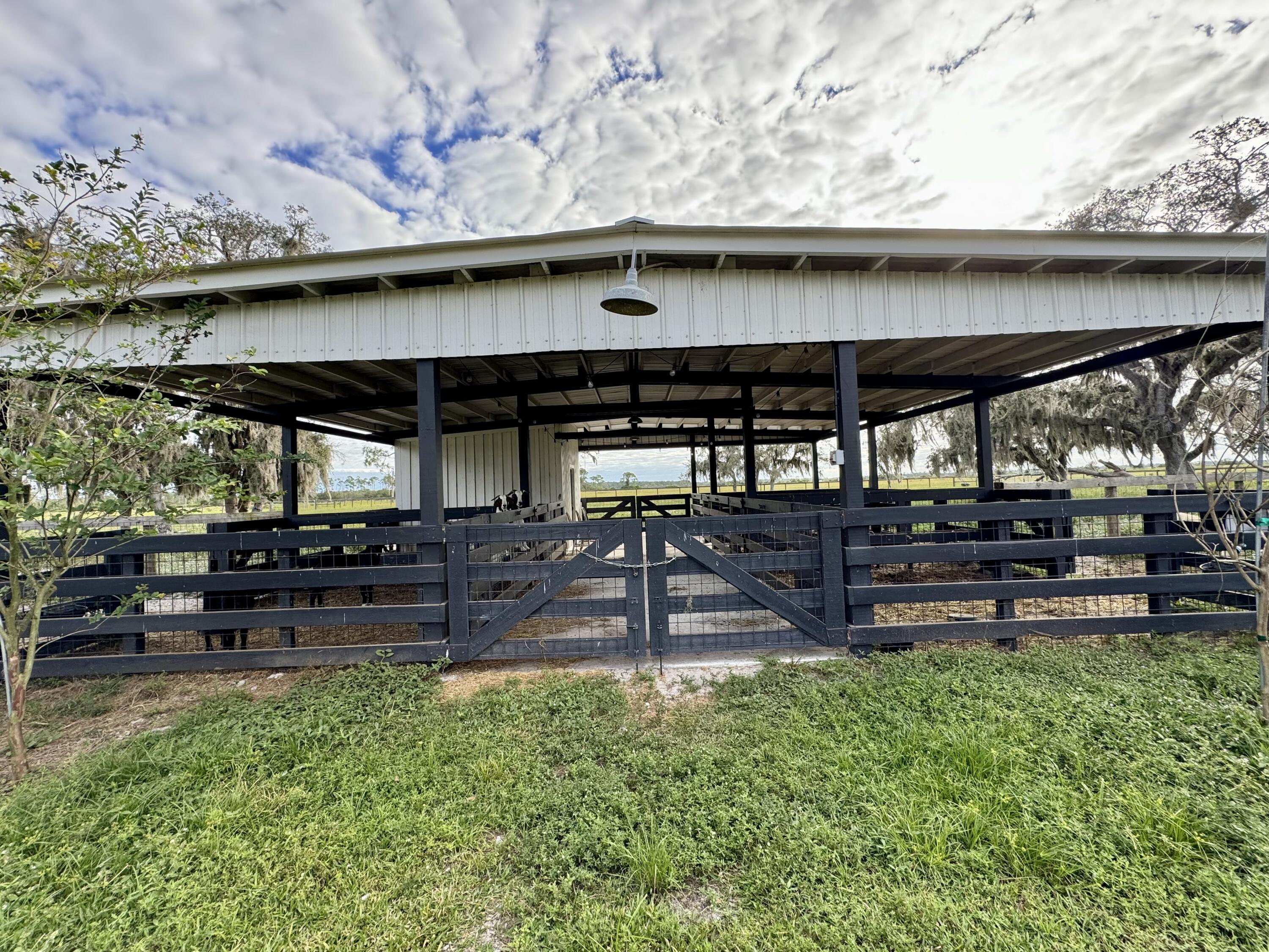 14151 Center Street Okeechobee, FL 34974 - Photo 5 of 16 a view of a backyard with plants and a patio