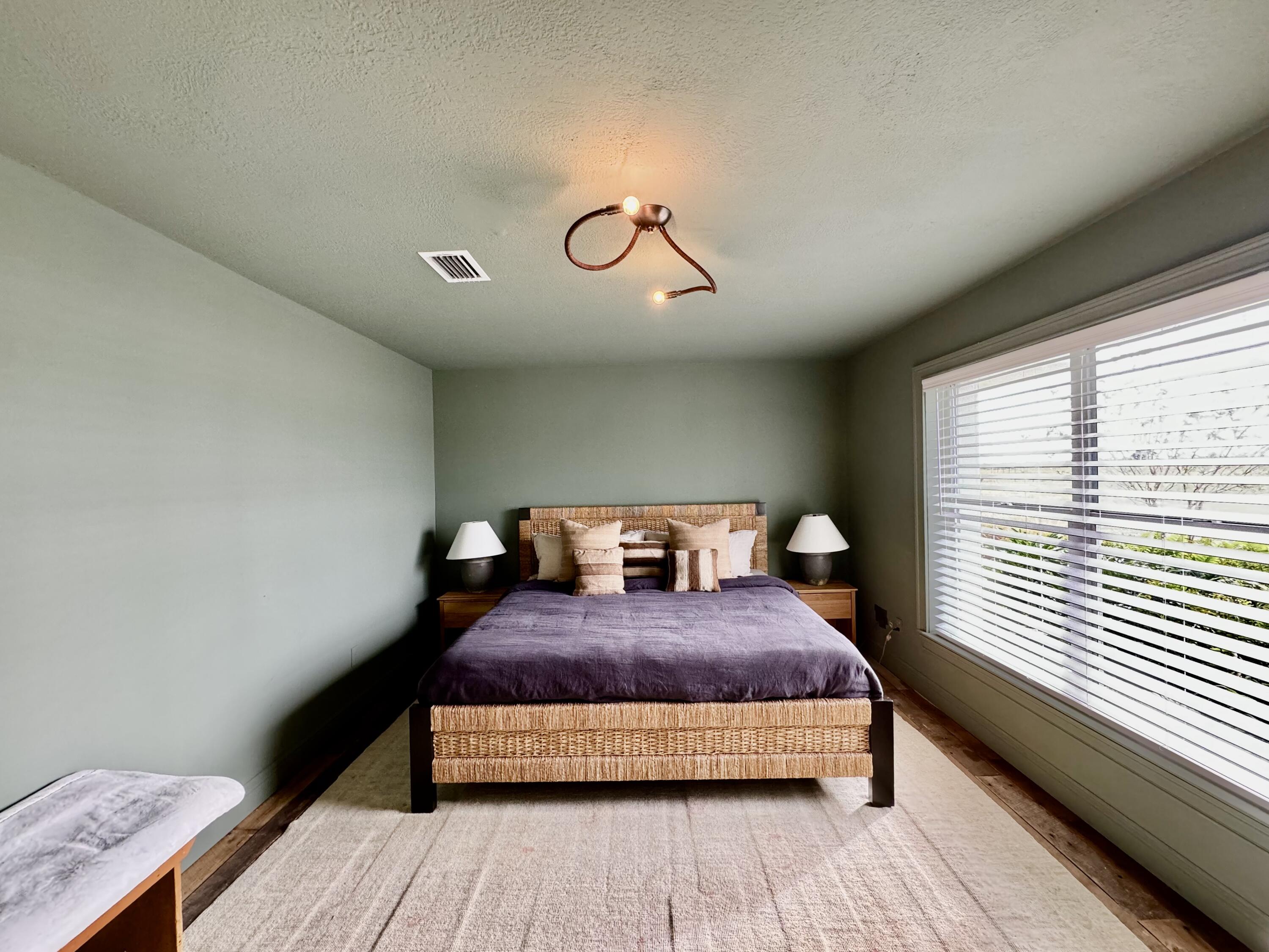 14151 Center Street Okeechobee, FL 34974 - Photo 7 of 16 a bedroom with a bed and wooden floor