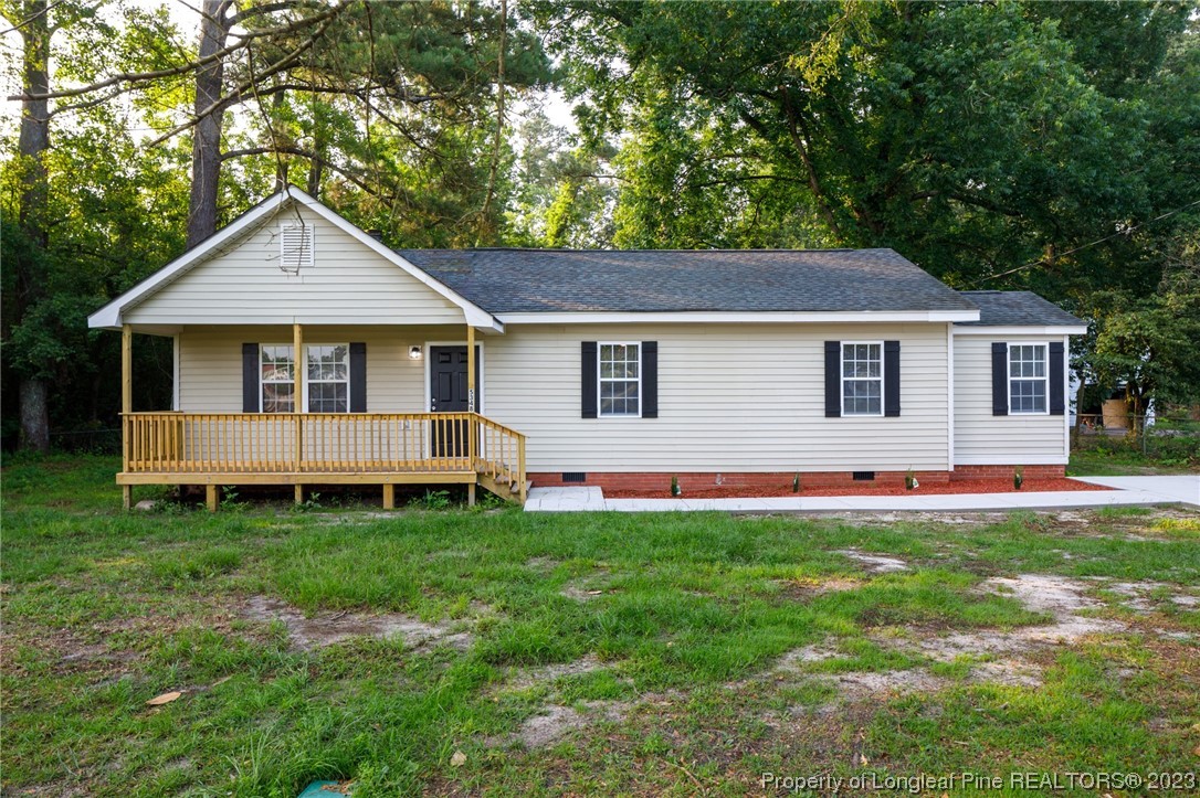 a front view of a house with a yard and porch