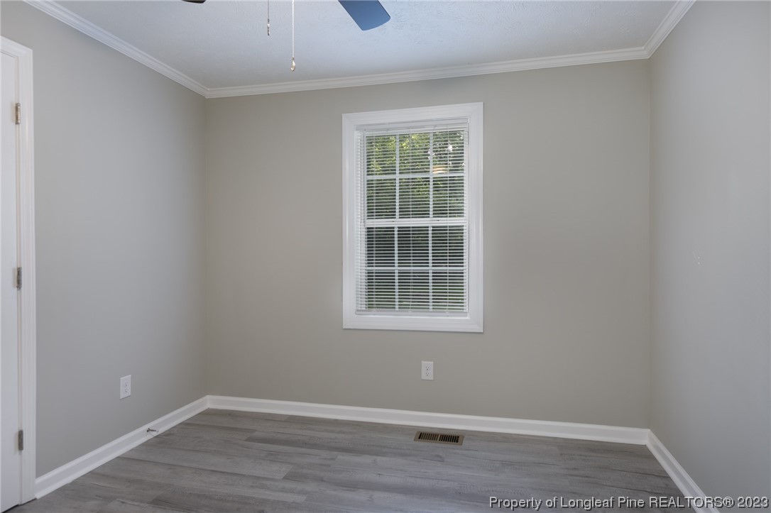 5348 Goldsboro Road Wade, NC 28395 - Photo 14 of 25 a view of an empty room with wooden floor and a window