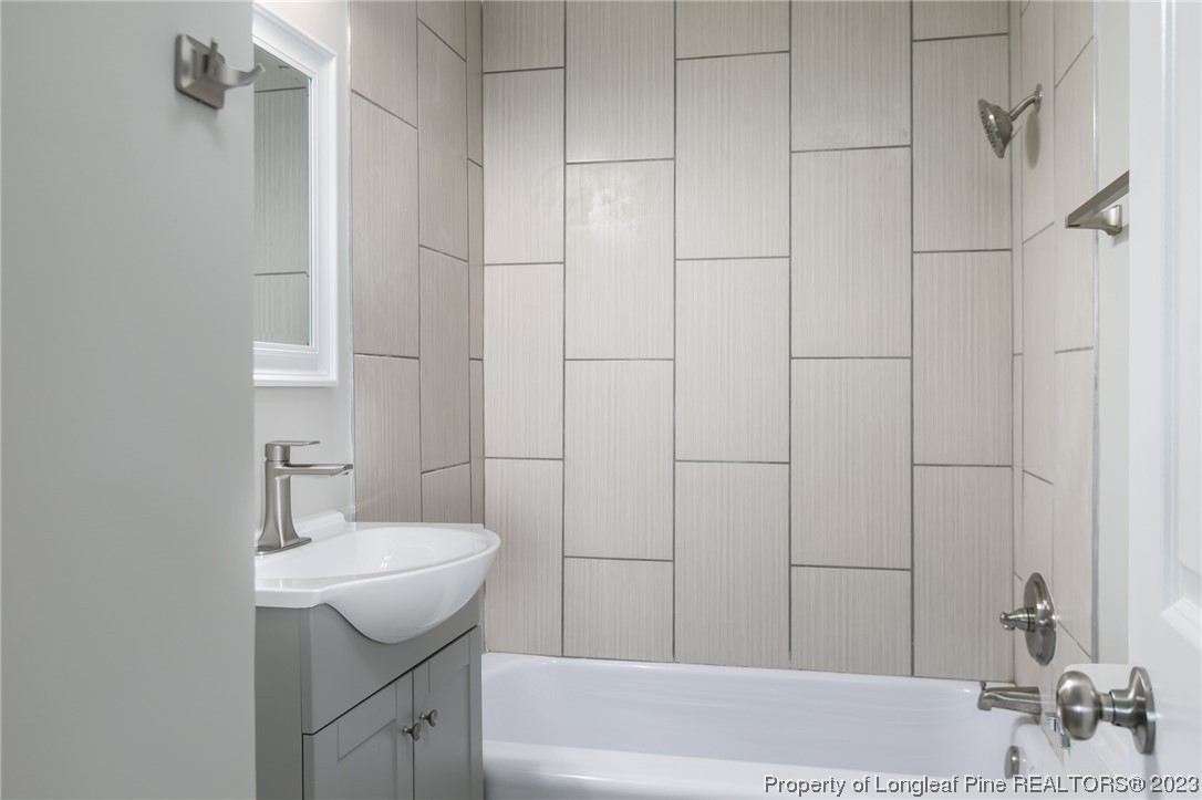 5348 Goldsboro Road Wade, NC 28395 - Photo 15 of 25 a bathroom with a sink a bathtub and shower