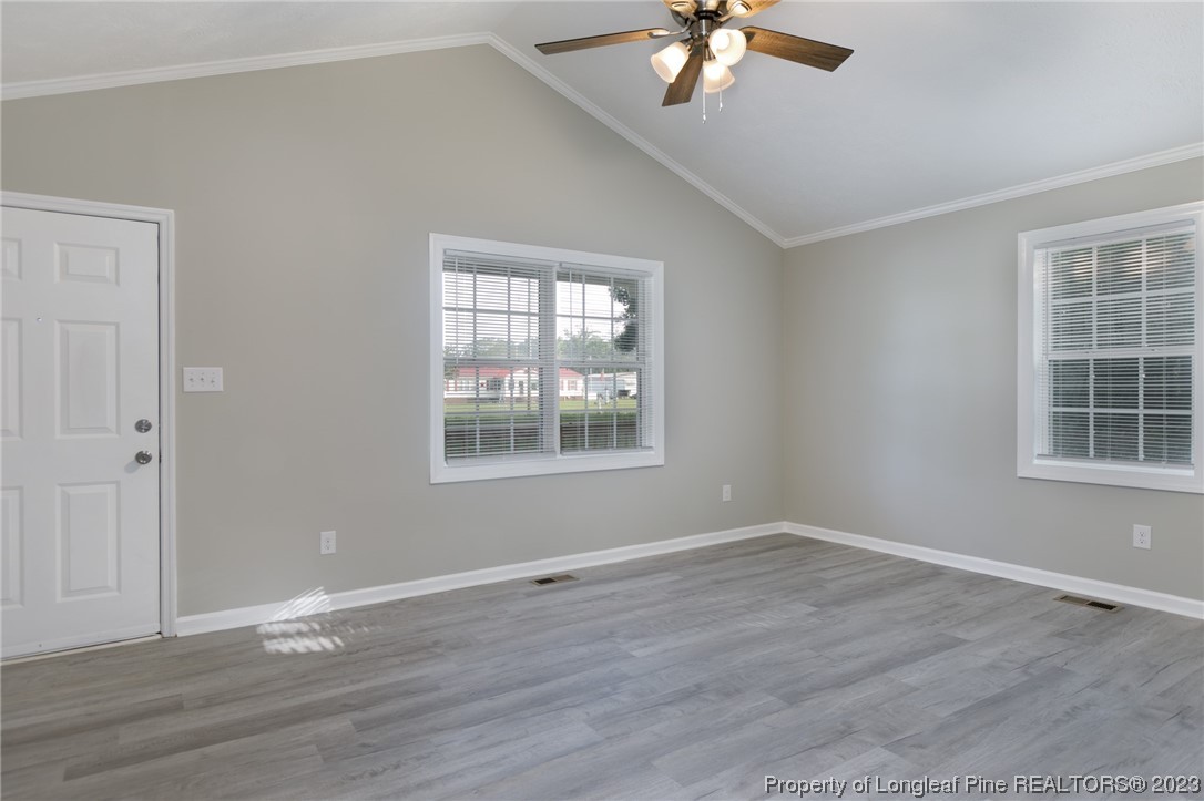5348 Goldsboro Road Wade, NC 28395 - Photo 4 of 25 a view of an empty room with wooden floor and a window