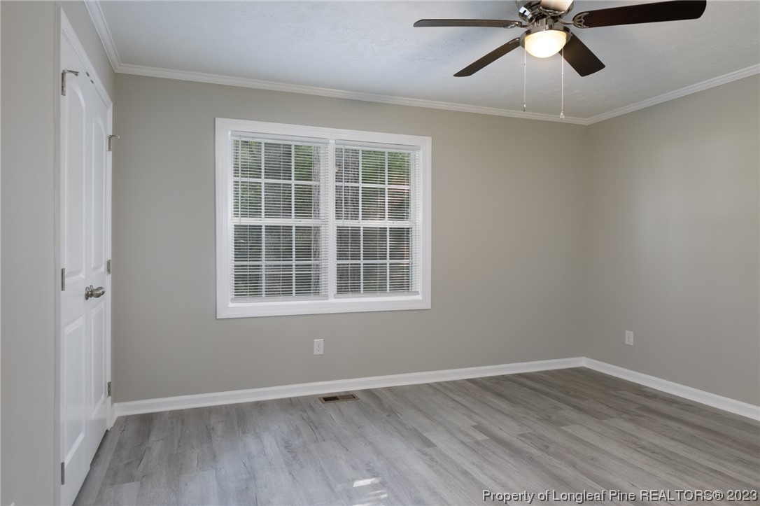 5348 Goldsboro Road Wade, NC 28395 - Photo 8 of 25 a view of an empty room with wooden floor and a window