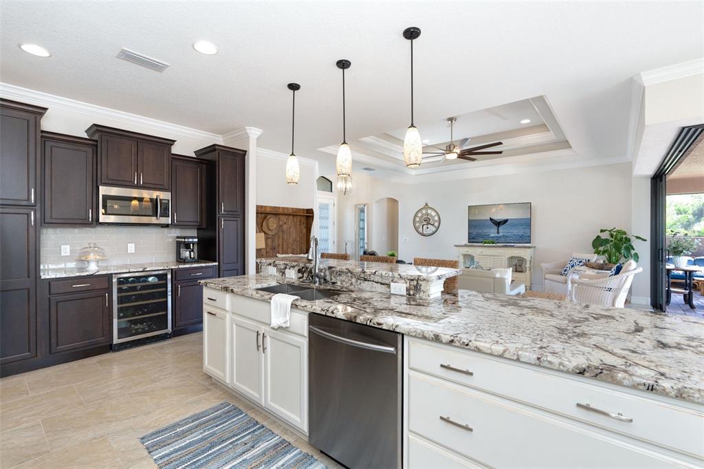 85 Spaniards Road Placida, FL 33946 - Photo 17 of 53 a kitchen with stainless steel appliances kitchen island granite countertop a stove a sink and a granite counter tops