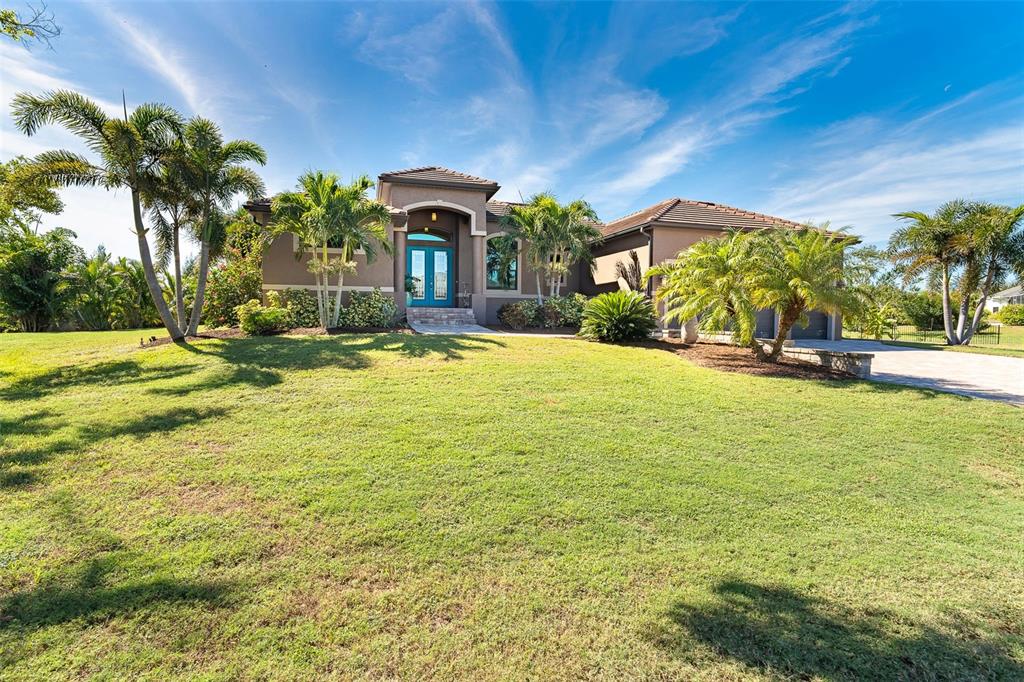 85 Spaniards Road Placida, FL 33946 - Photo 3 of 53 a swimming pool with outdoor seating and yard