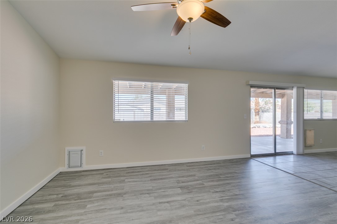2028 Rustler Ridge Avenue North Las Vegas, NV 89031 - Photo 10 of 40 Natural light pours into this spacious room featuring sleek flooring and a contemporary ceiling fan.
