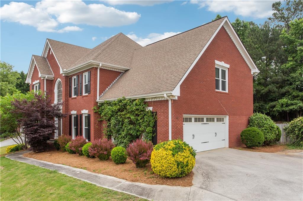 a front view of a house with garden