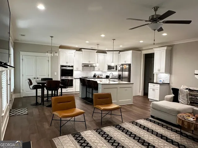 a living room kitchen with furniture and a view of kitchen