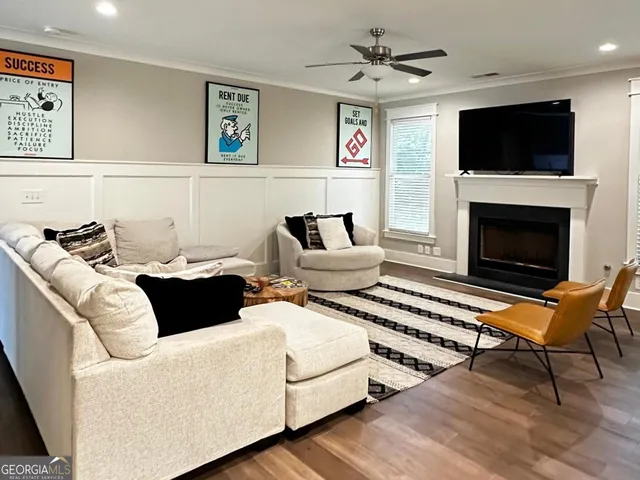 a living room with furniture a flat screen tv and a fireplace