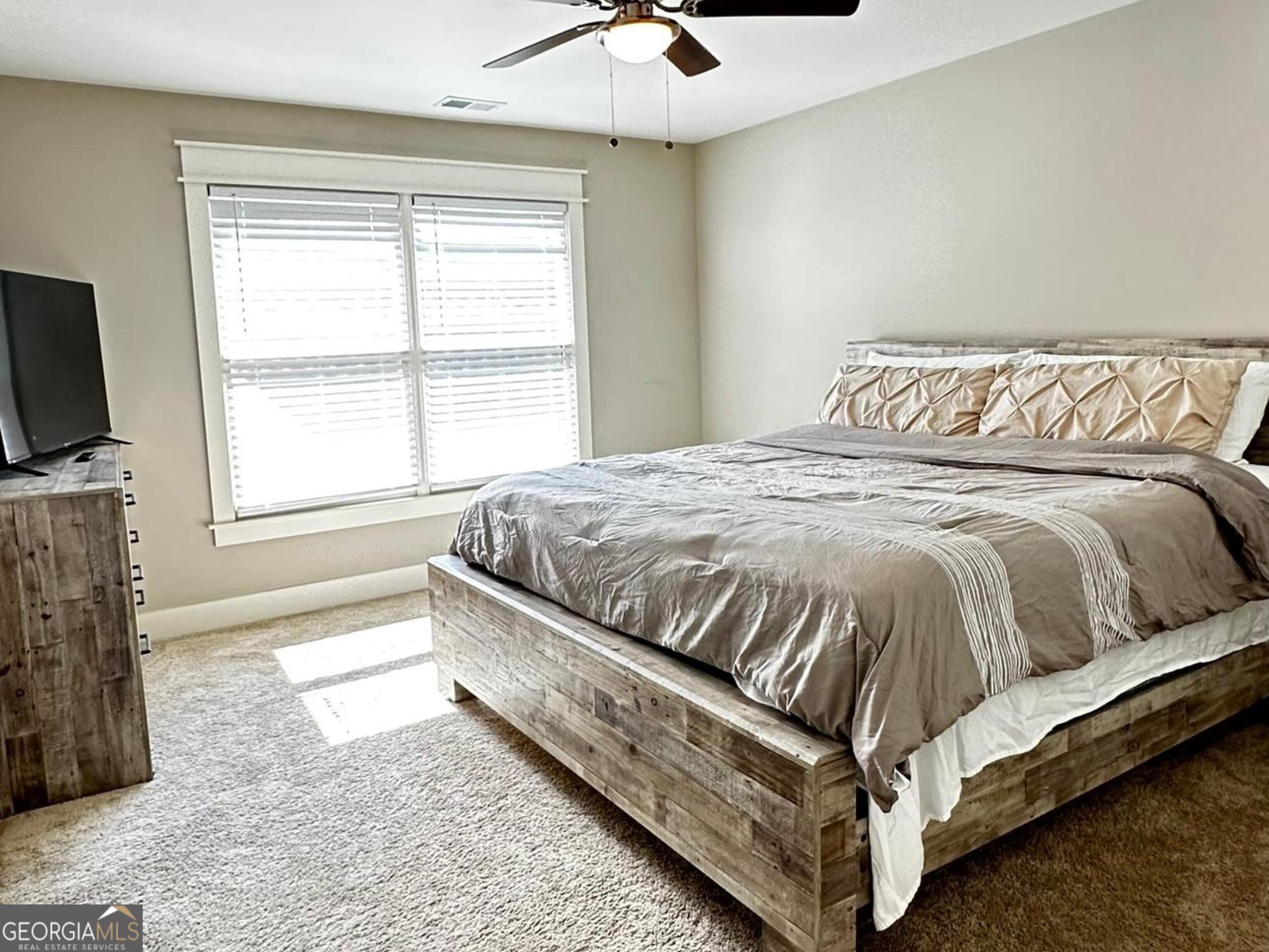 6247 Allen Ivey Road Mableton, GA 30126 - Photo 14 of 20 a bed sitting in a bedroom next to a window