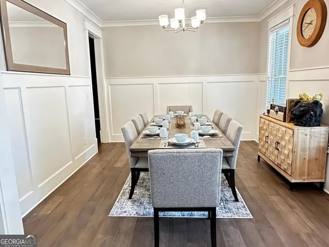 a view of a dining room with furniture and wooden floor