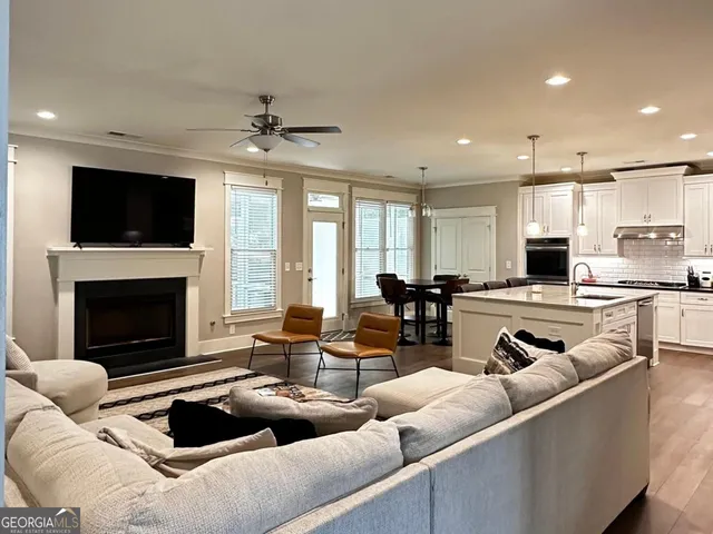a living room with furniture a fireplace and a flat screen tv