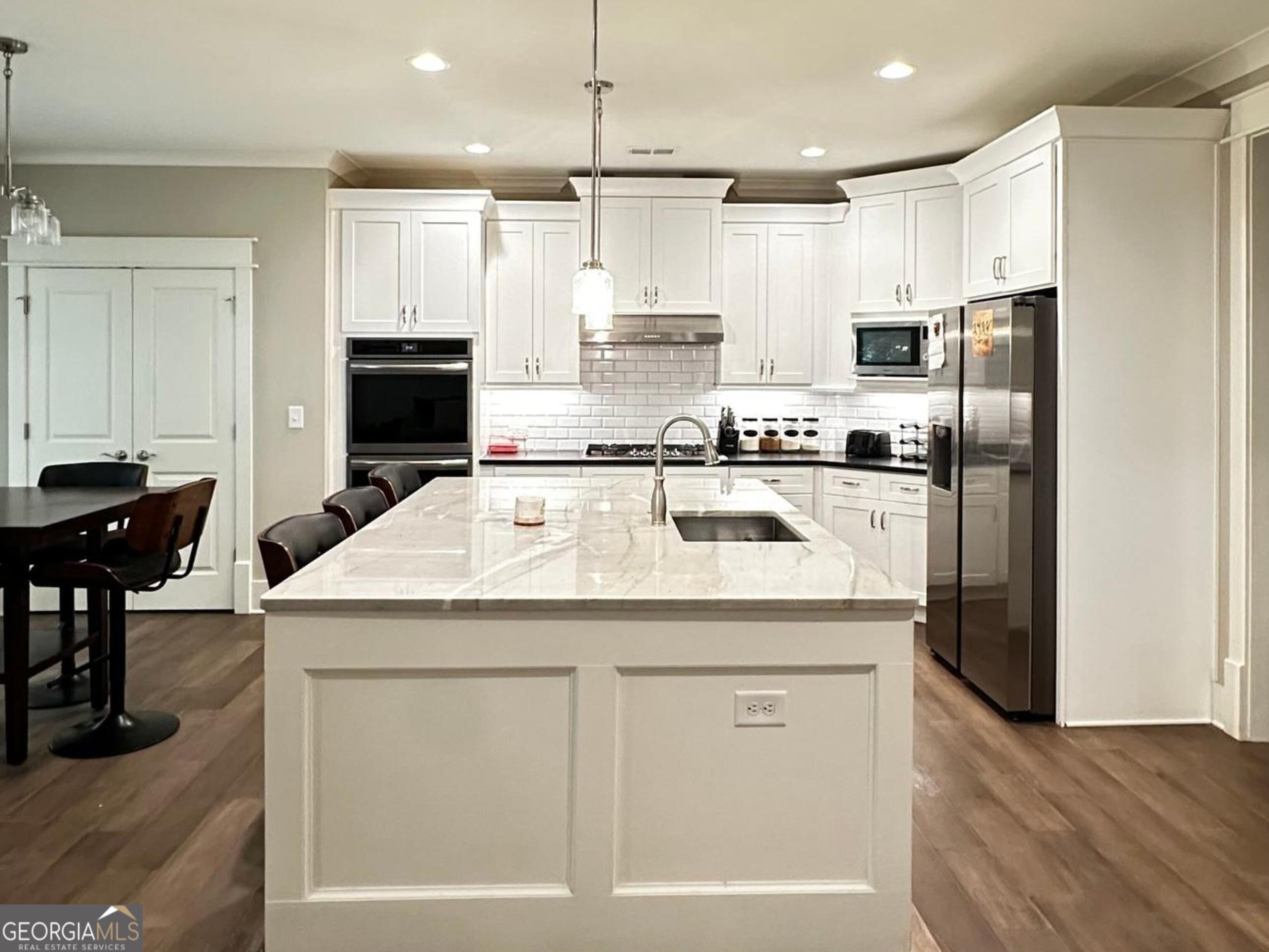 6247 Allen Ivey Road Mableton, GA 30126 - Photo 7 of 20 a kitchen with stainless steel appliances granite countertop a kitchen island a stove a refrigerator a sink and a island