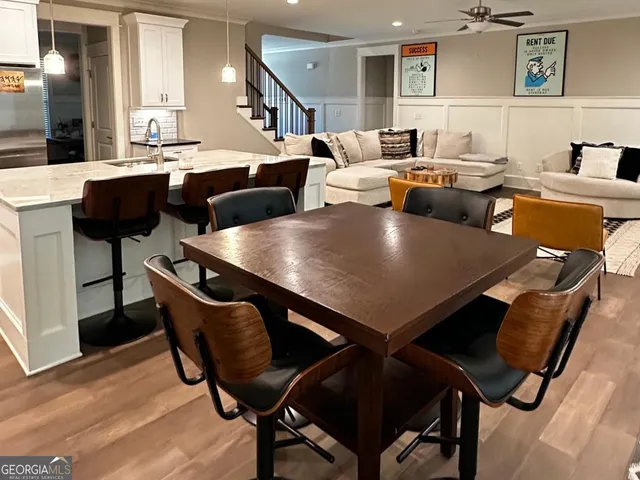 a living room with couches chairs and rug