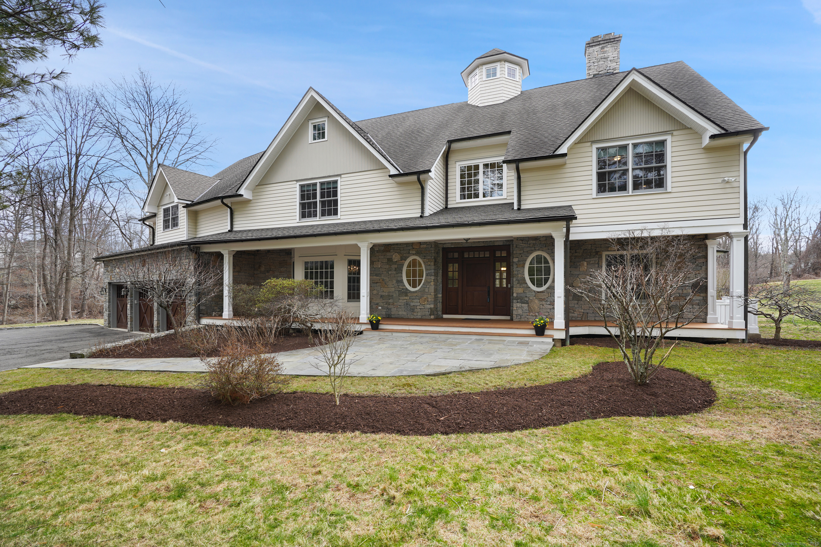a front view of a house with garden and porch