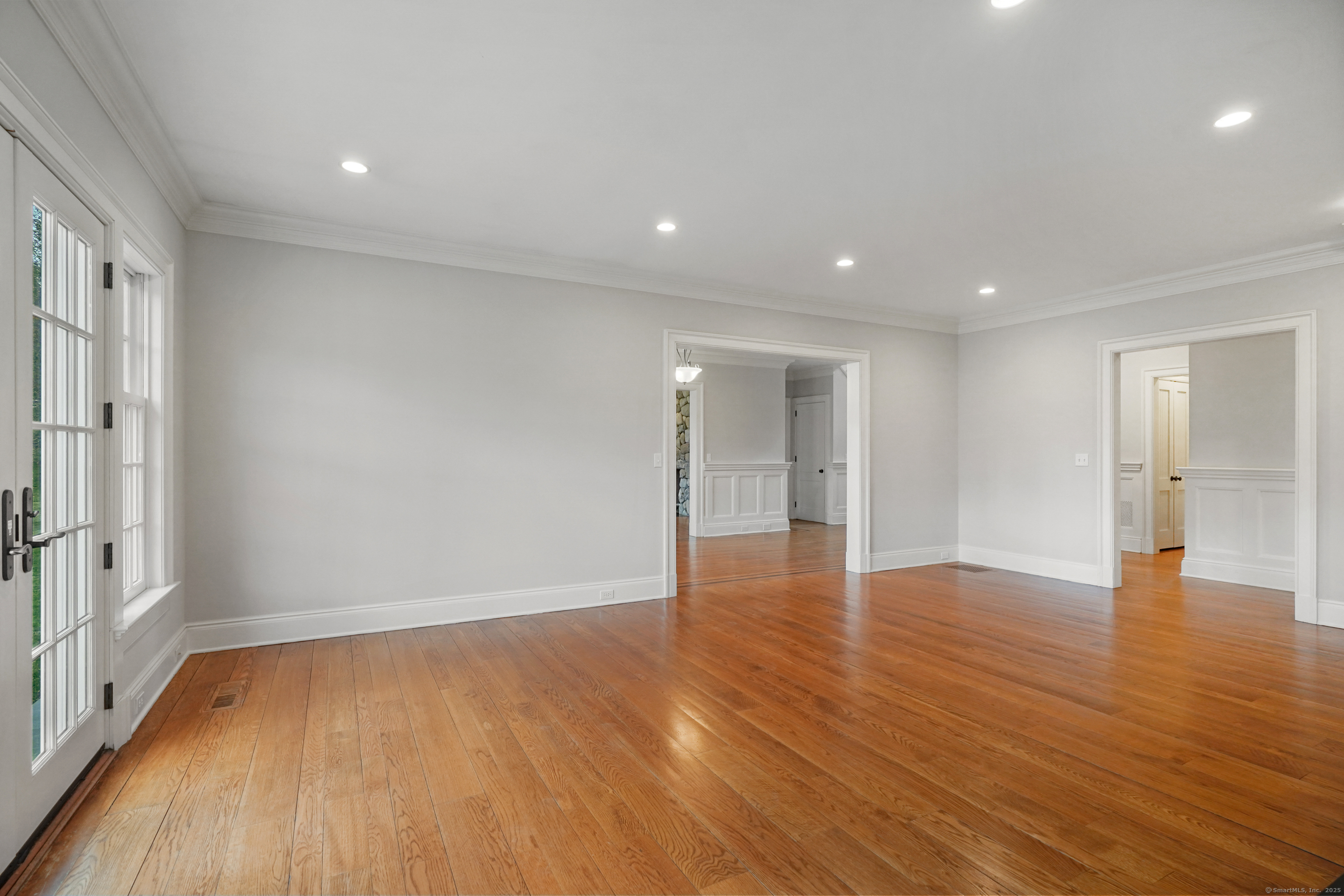 33 Middlebrook Farm Road Wilton, CT 06897 - Photo 14 of 40 a view of an empty room with wooden floor and a window