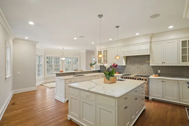 a kitchen with a sink stove and wooden cabinets