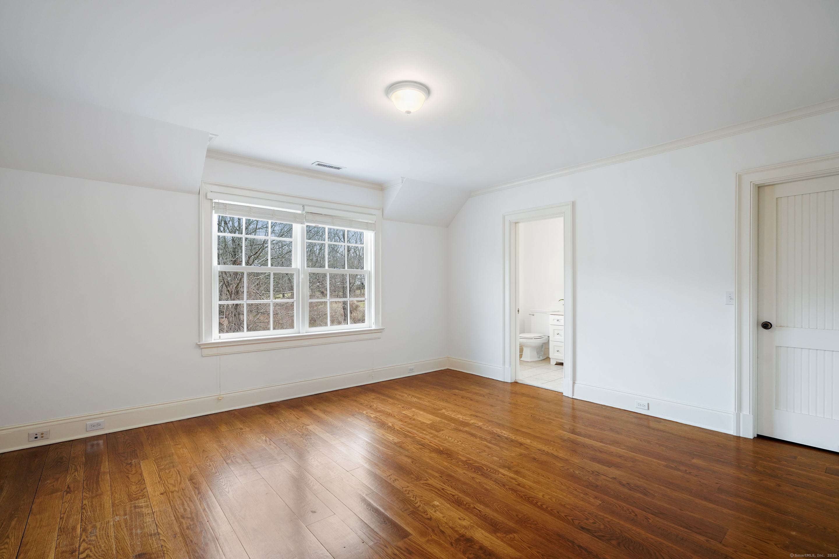 33 Middlebrook Farm Road Wilton, CT 06897 - Photo 27 of 40 a view of an empty room with wooden floor and a window