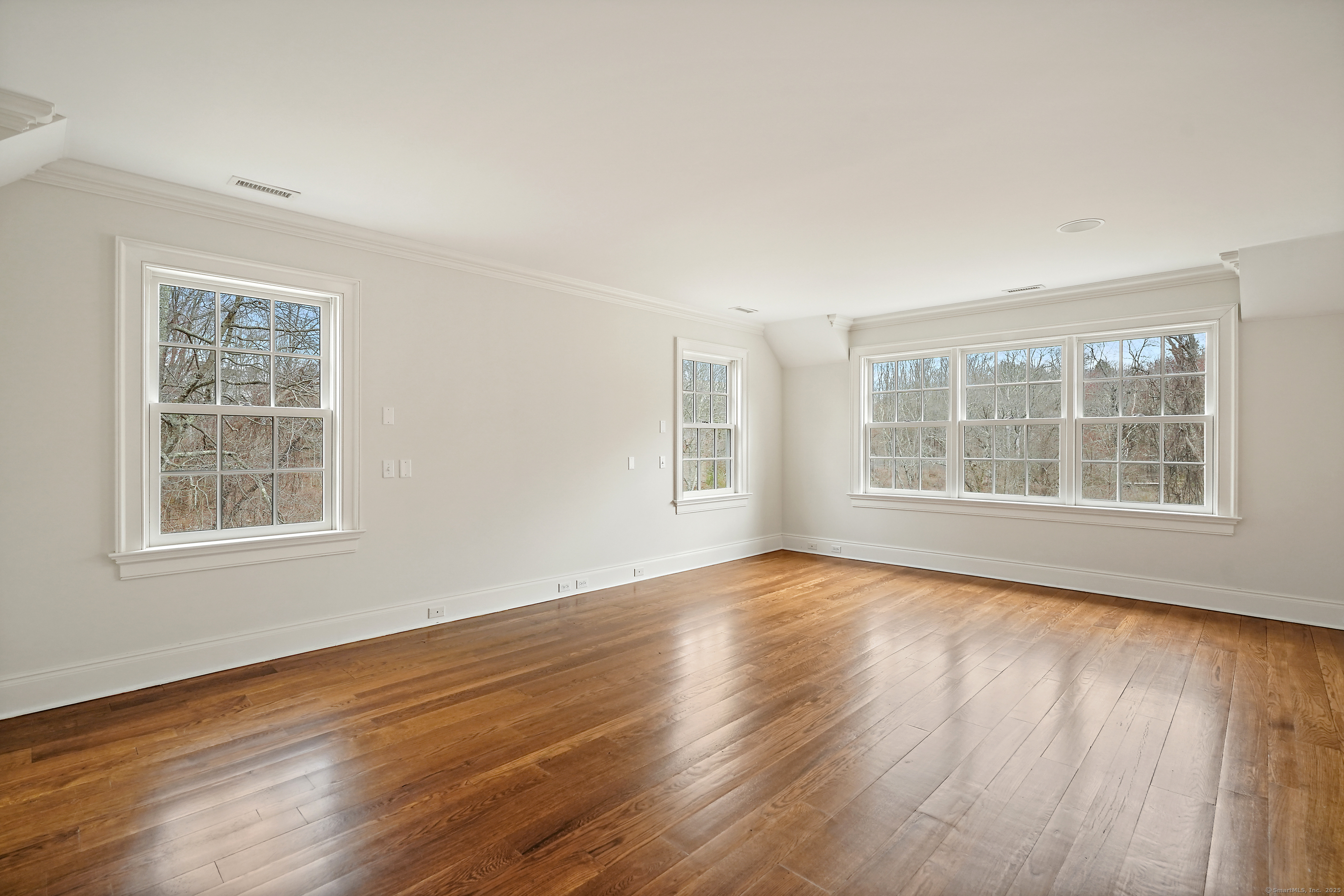33 Middlebrook Farm Road Wilton, CT 06897 - Photo 31 of 40 a view of an empty room with wooden floor and windows