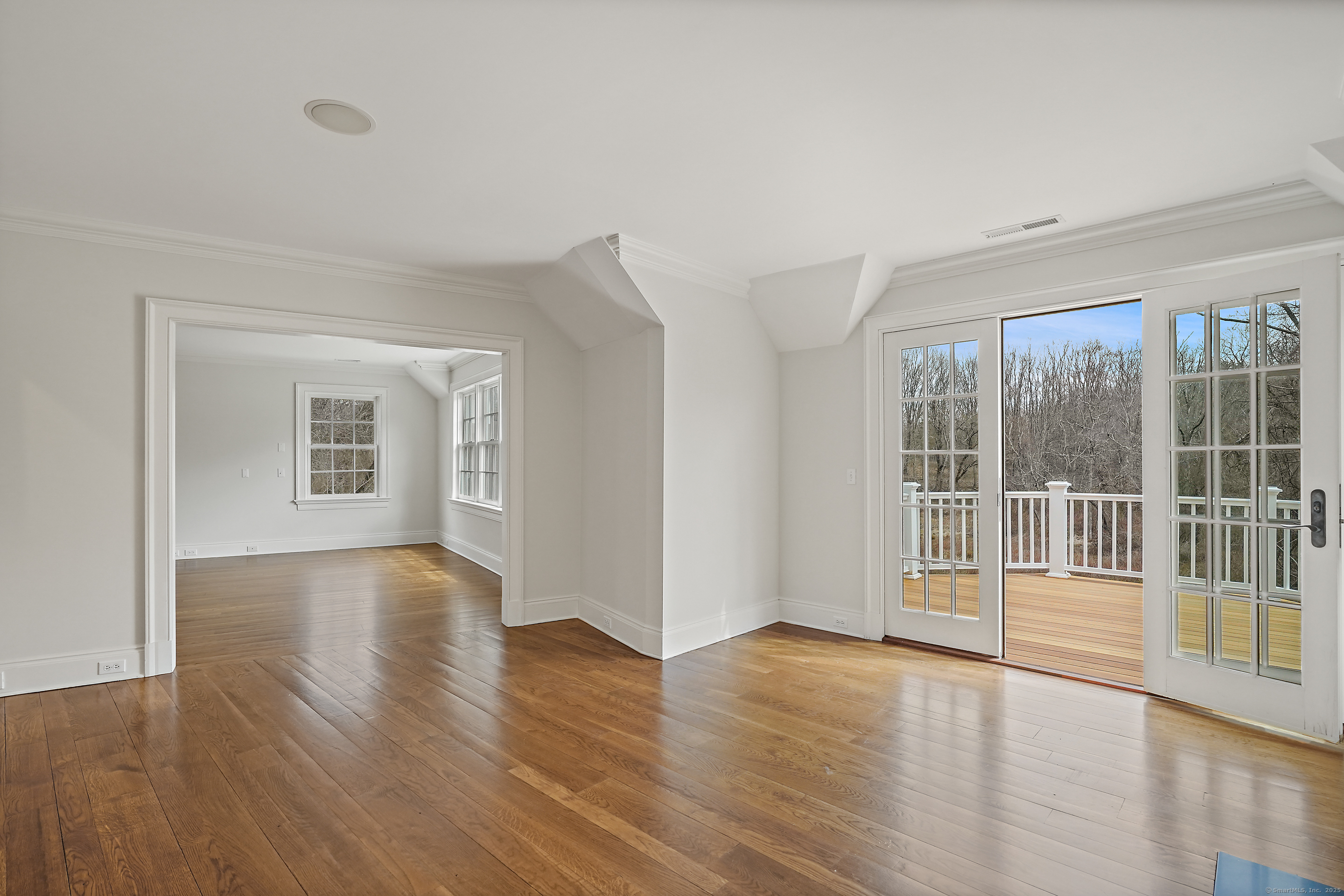 33 Middlebrook Farm Road Wilton, CT 06897 - Photo 33 of 40 a view of an empty room with wooden floor and a window