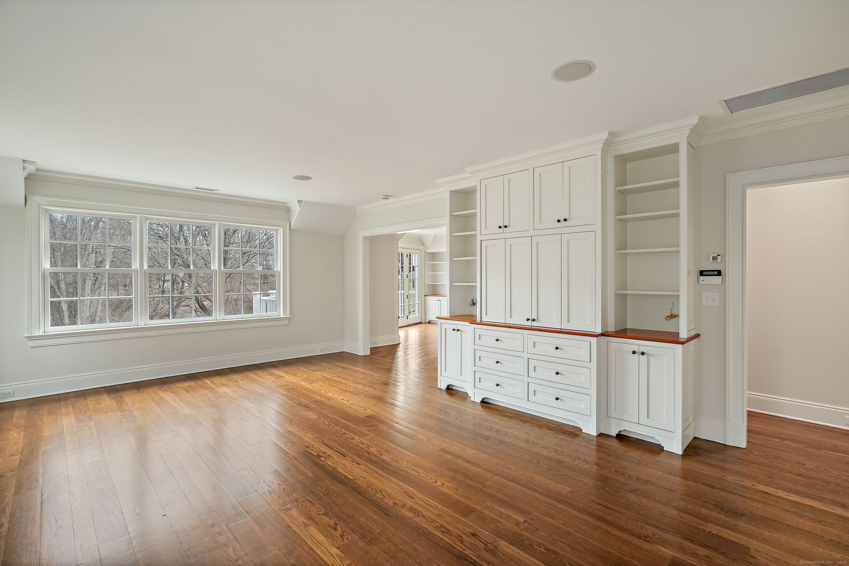 33 Middlebrook Farm Road Wilton, CT 06897 - Photo 39 of 40 an empty room with wooden floor and windows