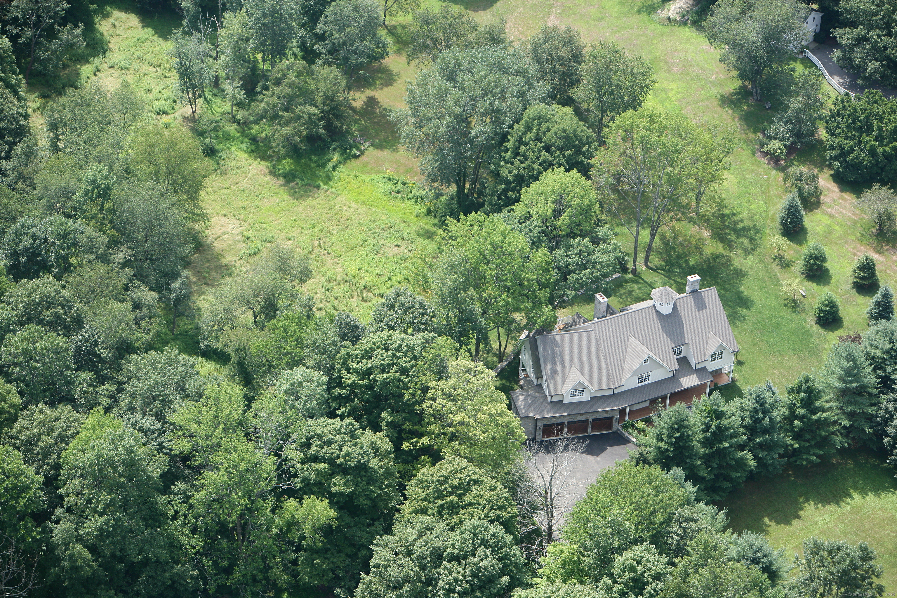 33 Middlebrook Farm Road Wilton, CT 06897 - Photo 39 of 40 an aerial view of a house with a yard and lake view