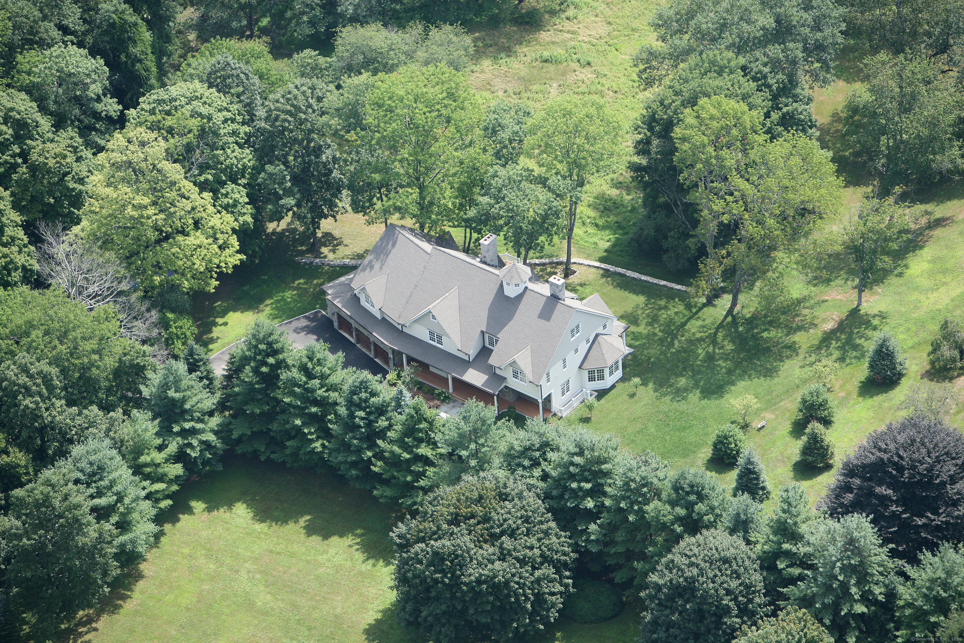 33 Middlebrook Farm Road Wilton, CT 06897 - Photo 40 of 40 an aerial view of a house with pool outdoor seating and yard