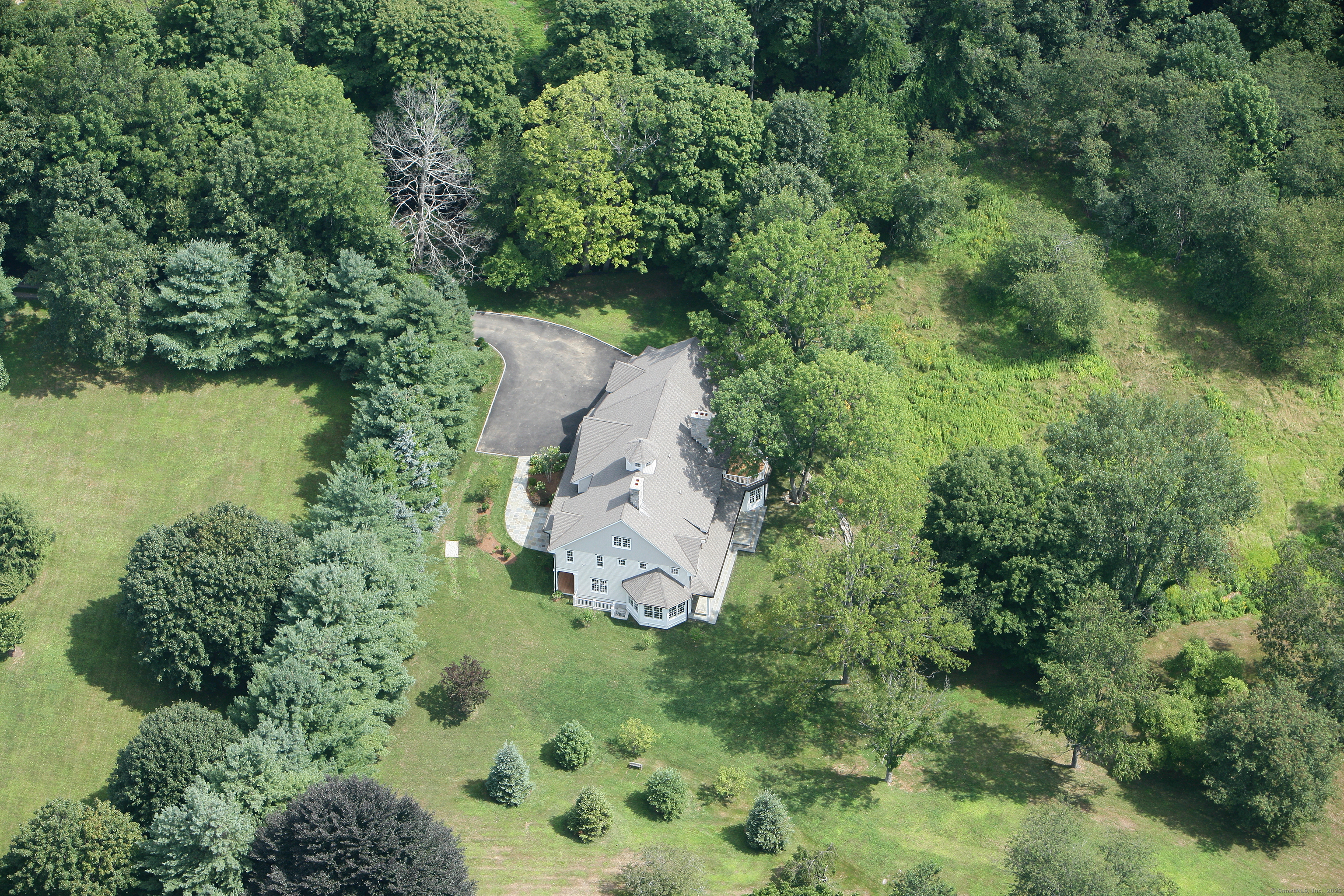 33 Middlebrook Farm Road Wilton, CT 06897 - Photo 4 of 40 an aerial view of residential house with outdoor space and trees all around