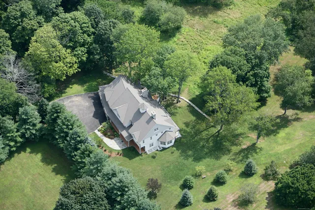an aerial view of a house with a yard basket ball court and outdoor seating