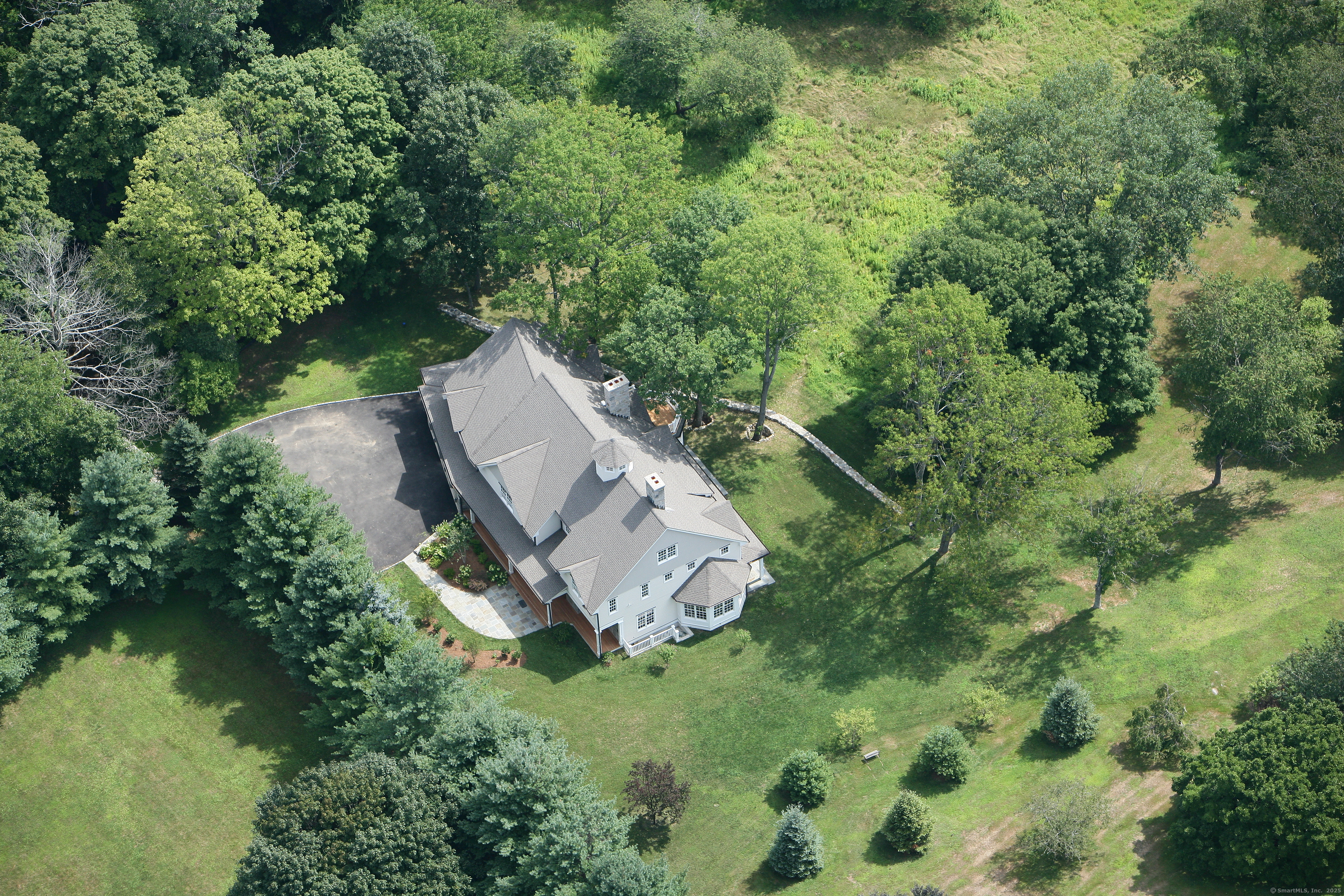 33 Middlebrook Farm Road Wilton, CT 06897 - Photo 5 of 40 an aerial view of a house with a yard basket ball court and outdoor seating