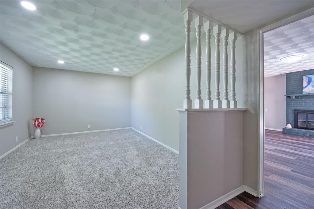 5220 Darlene Street Dallas, TX 75232 - Photo 5 of 16 an empty room with wooden floor and windows