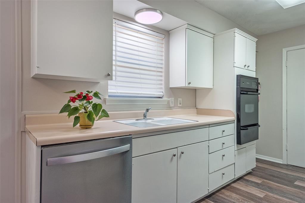 5220 Darlene Street Dallas, TX 75232 - Photo 6 of 16 a kitchen with white cabinets and sink