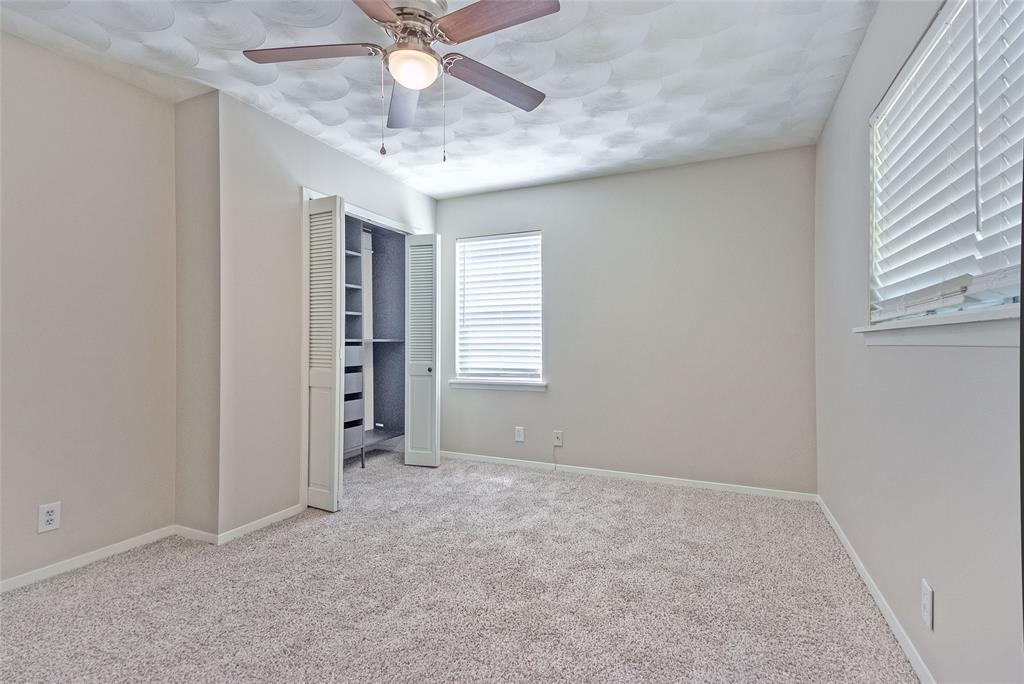 5220 Darlene Street Dallas, TX 75232 - Photo 7 of 16 an empty room with chandelier fan and windows