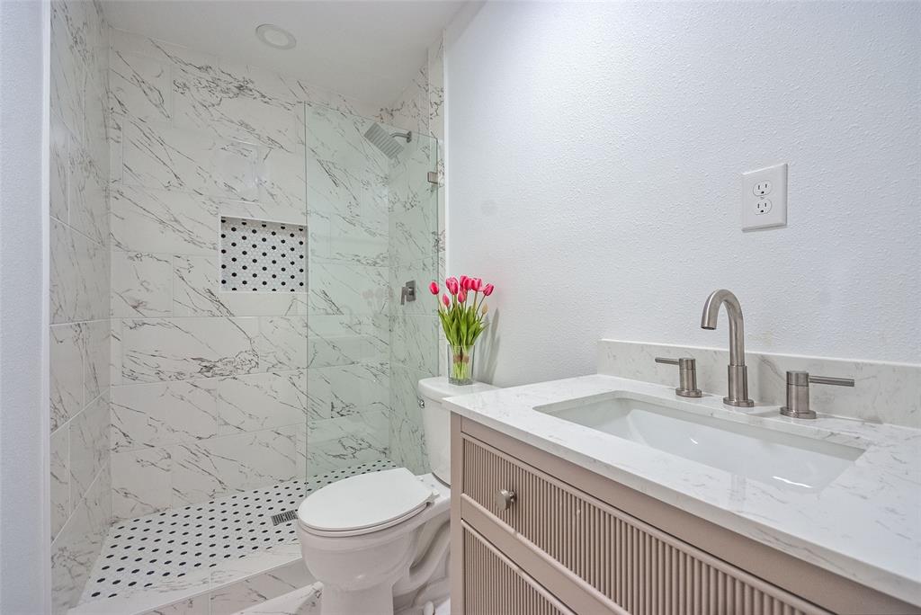 5220 Darlene Street Dallas, TX 75232 - Photo 8 of 16 a bathroom with a sink toilet and a mirror