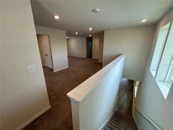 an empty room with closet and mirror