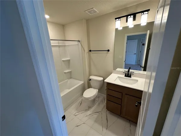 a bathroom with a double vanity sink and mirror