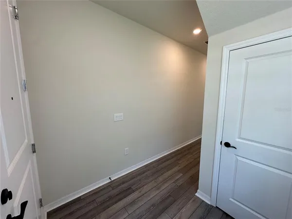 a view of hallway with wooden floor