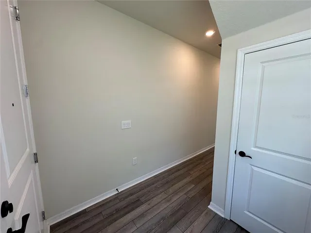 a view of hallway with wooden floor