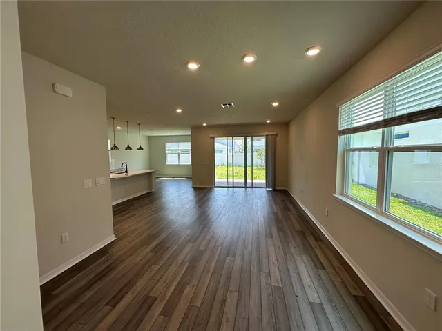 a large kitchen with stainless steel appliances granite countertop a large window